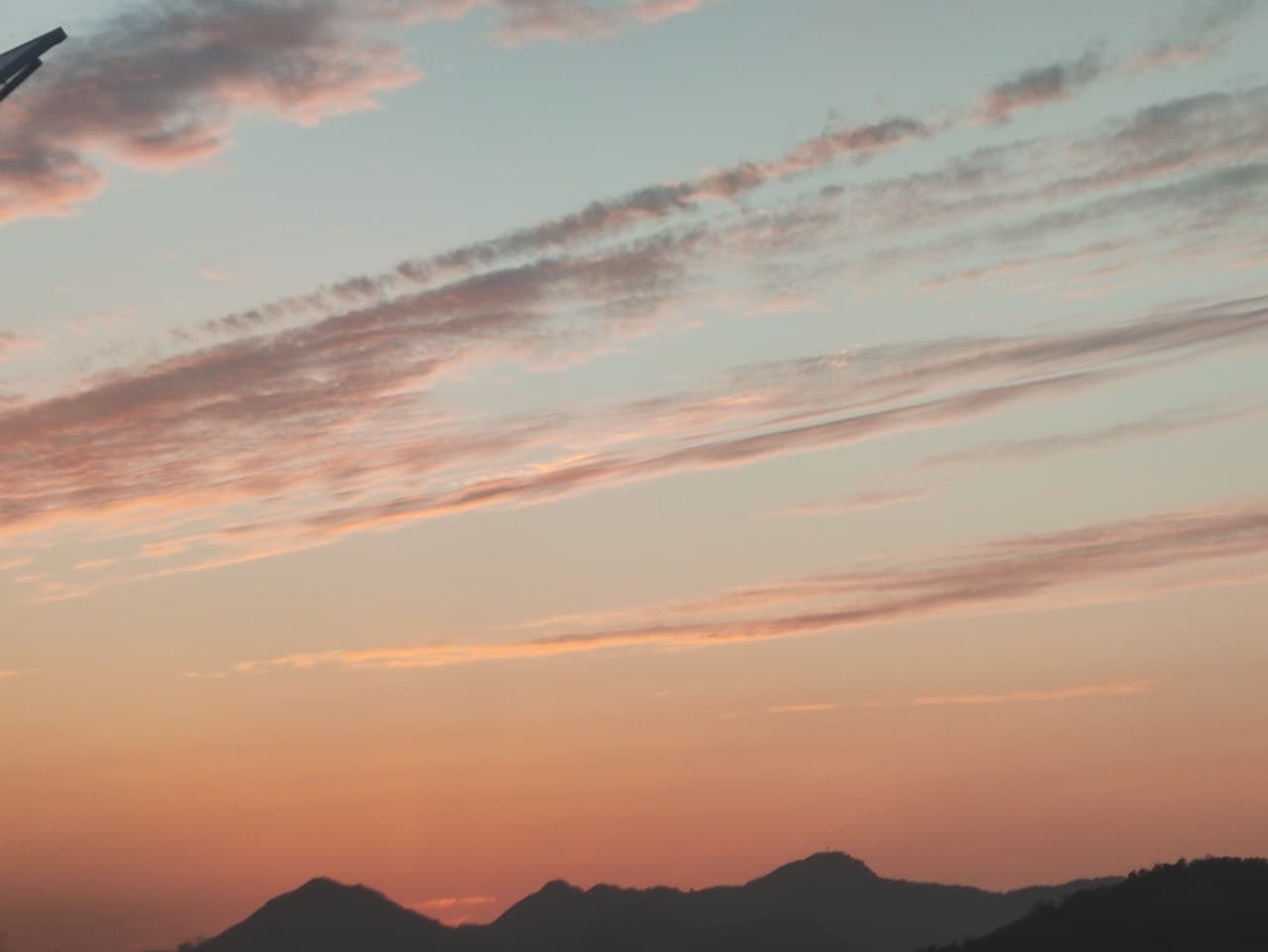 Nestled between mountains and the sea, the sunset is the most beautiful scenery.