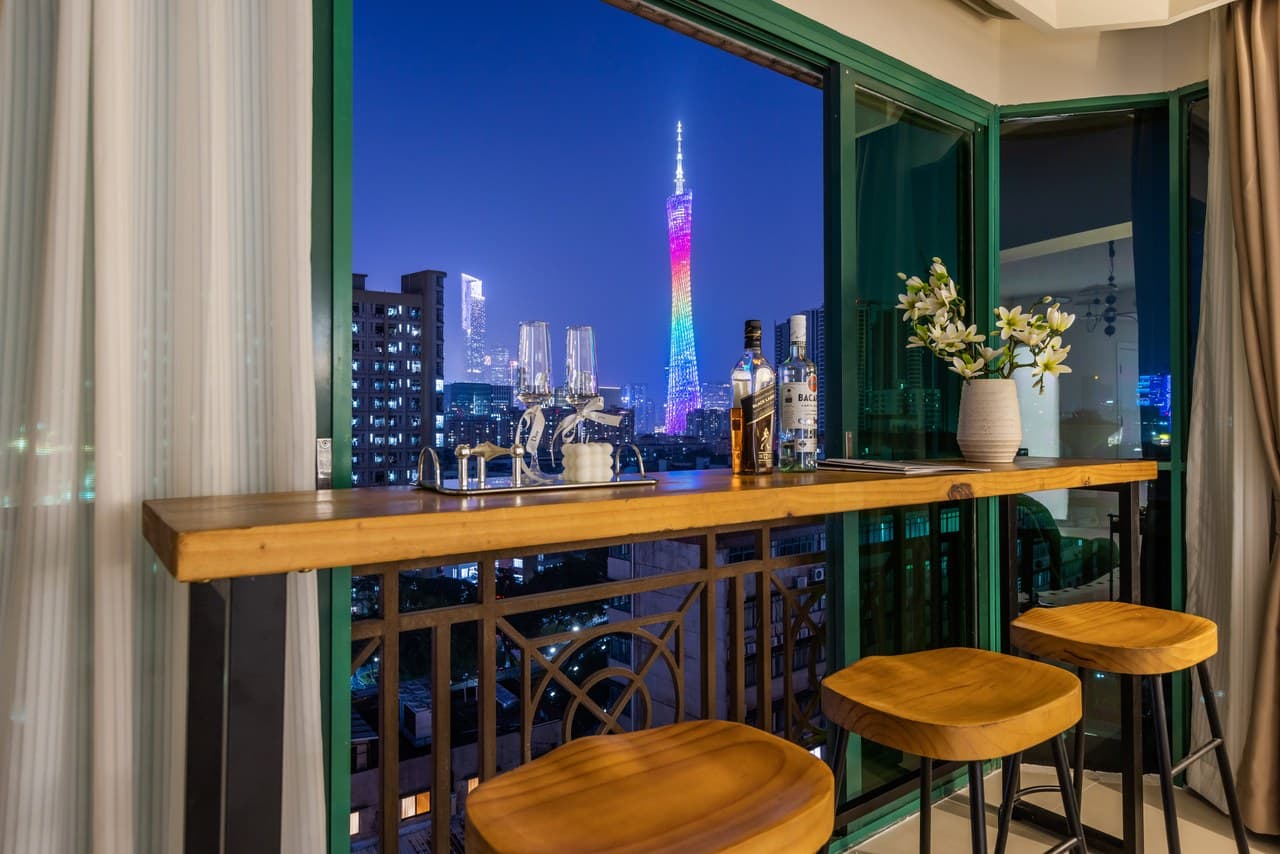 Panoramic floor-to-ceiling windows offer stunning views of the Canton Tower at night.