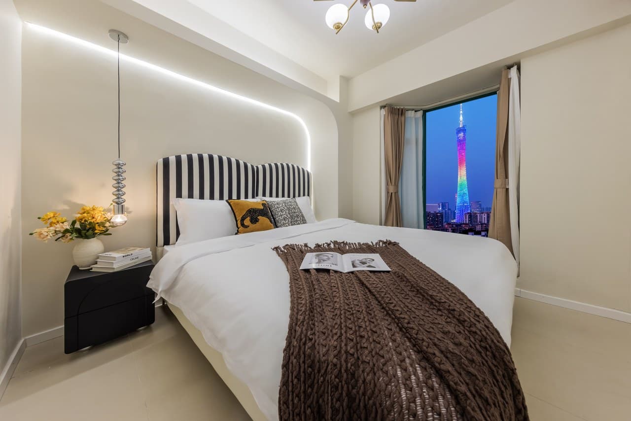 Panoramic floor-to-ceiling windows offer stunning views of the Canton Tower at night.