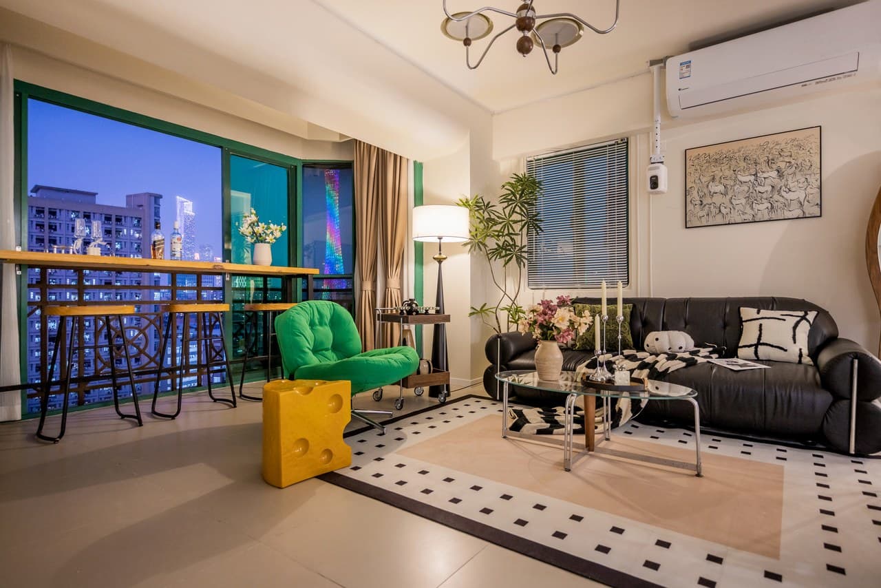 Panoramic floor-to-ceiling windows offer stunning views of the Canton Tower at night.