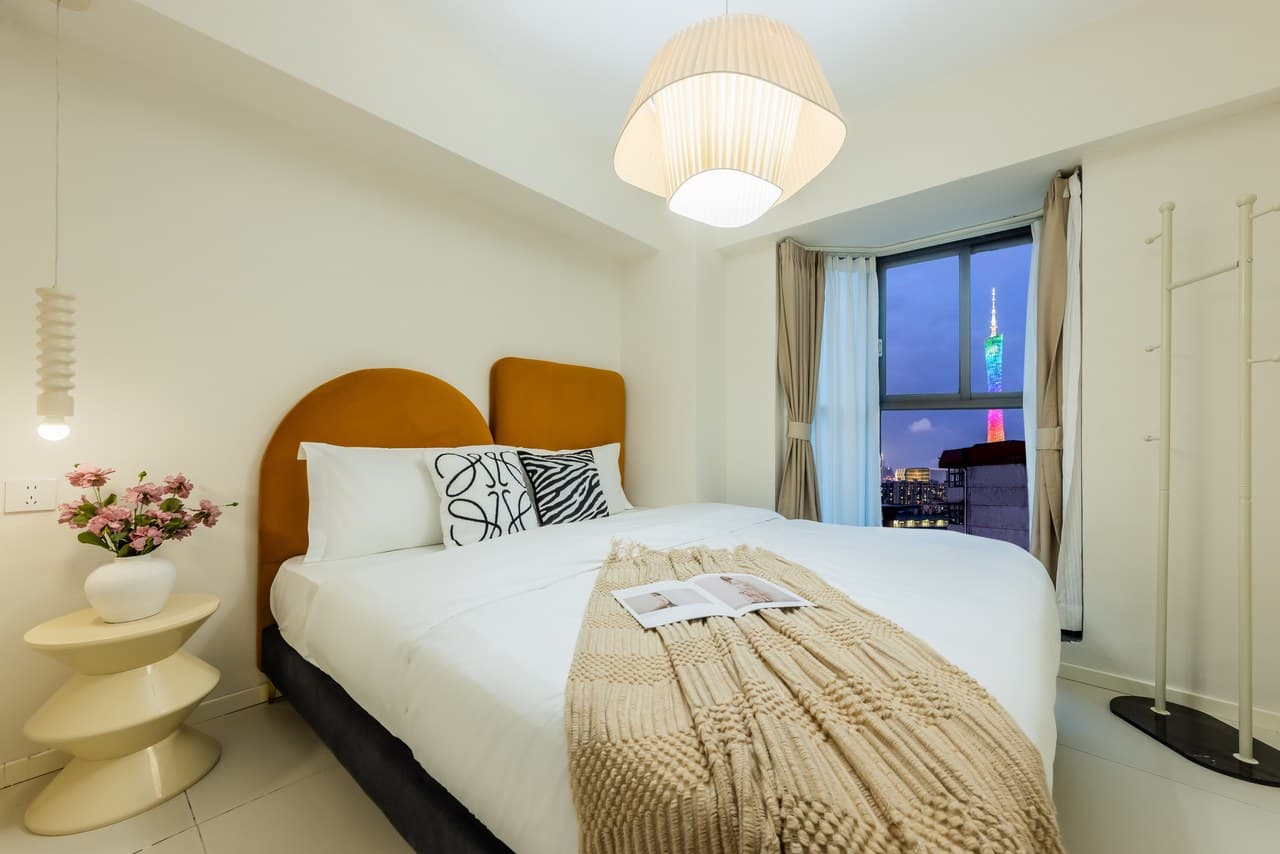 Panoramic floor-to-ceiling windows offer stunning views of the Canton Tower at night.