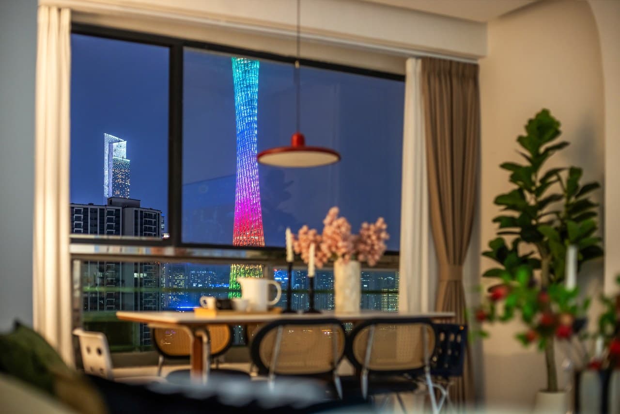 Panoramic floor-to-ceiling windows offer stunning views of the Canton Tower at night.