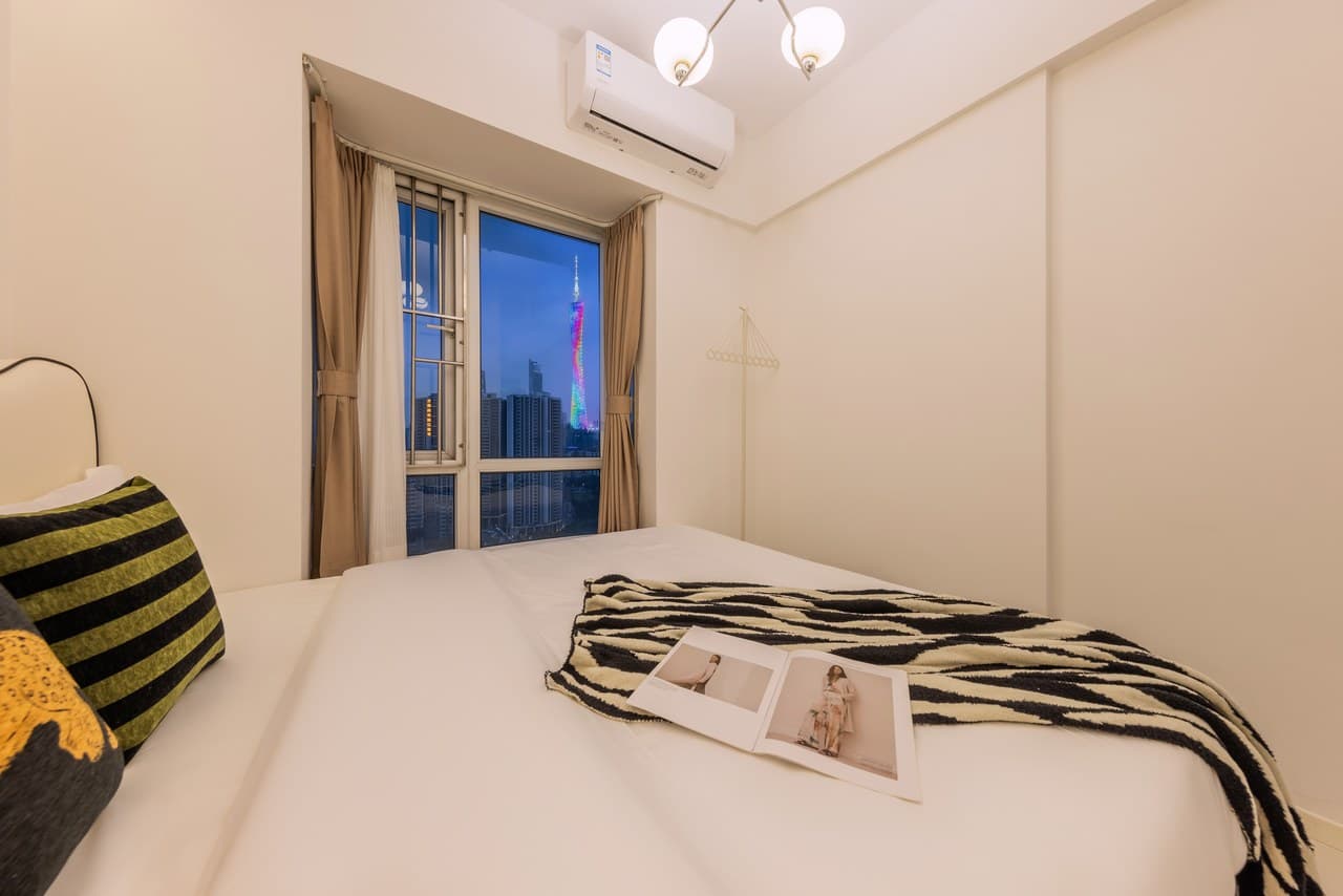 Panoramic floor-to-ceiling windows offer stunning views of the Canton Tower at night.