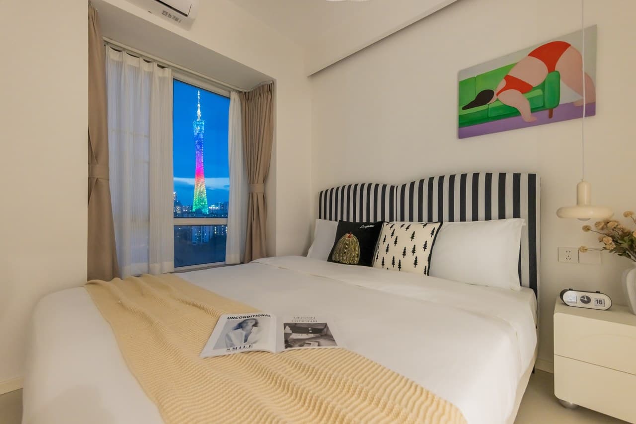 Panoramic floor-to-ceiling windows offer stunning views of the Canton Tower at night.